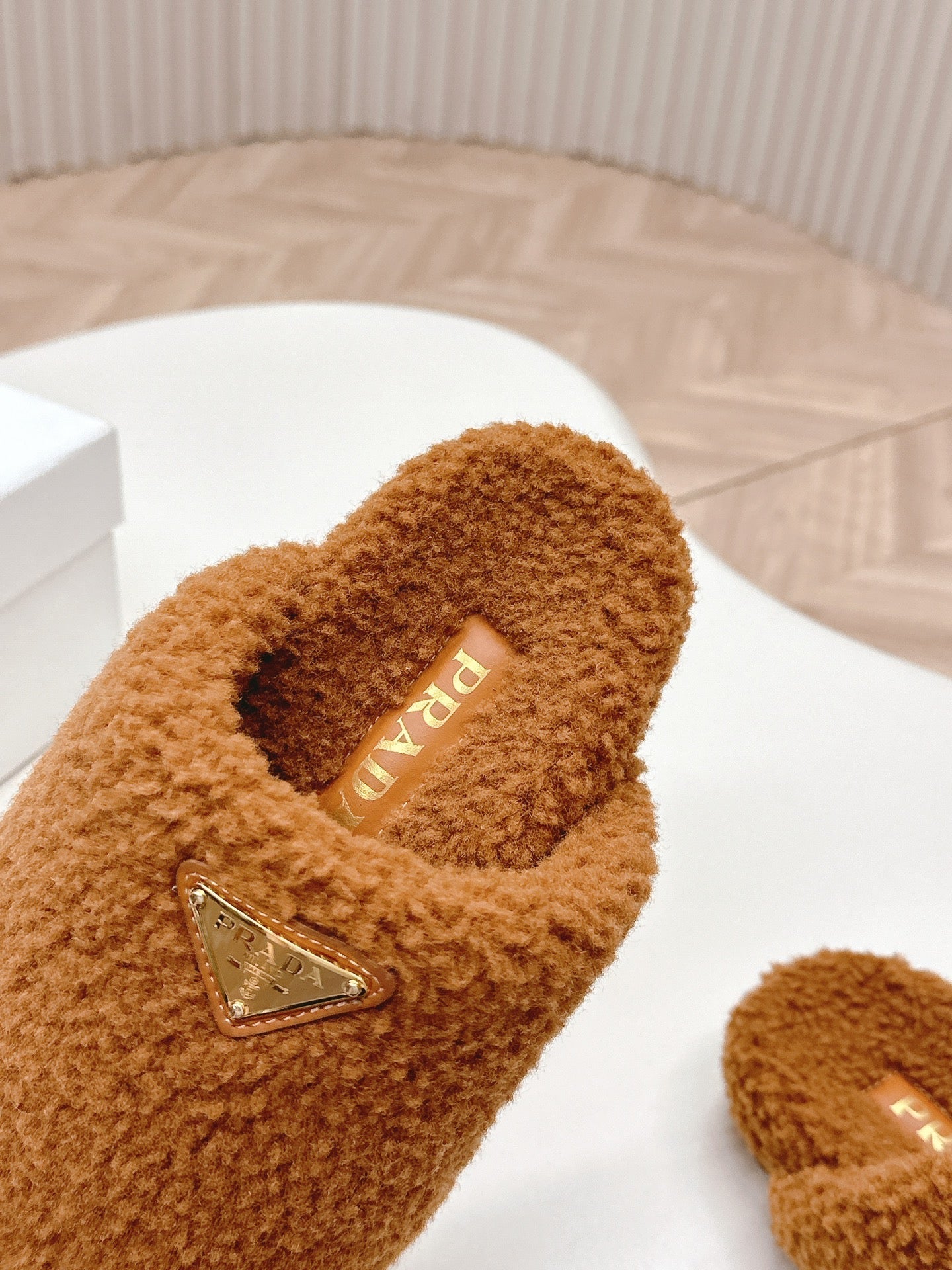 PRADA MULES ATTACHED TRIANGLE LOGO IN BRONZE BROWN SHEARLING