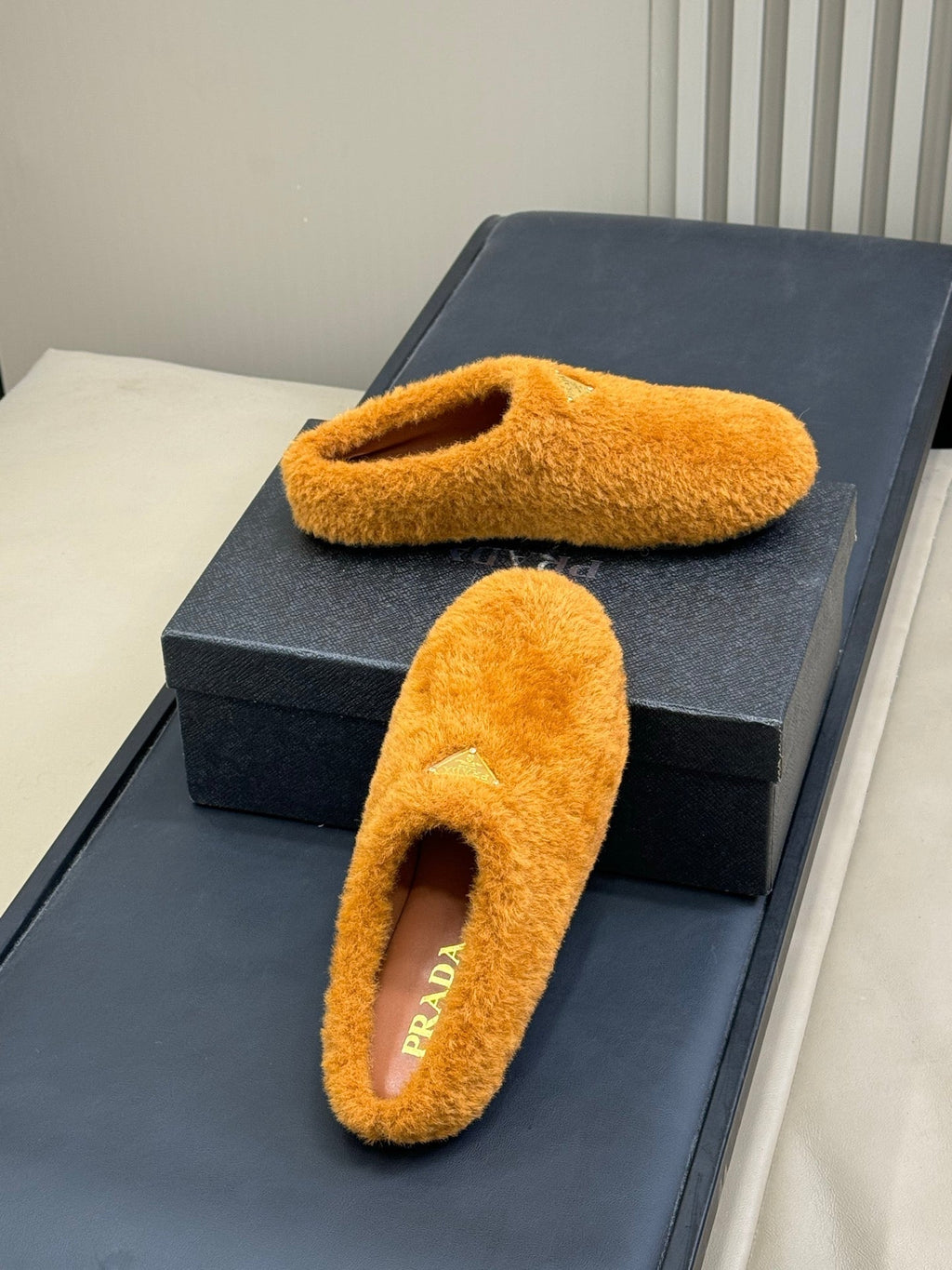 PRADA 25S CLOGS IN RK ORANGE SHEARLING